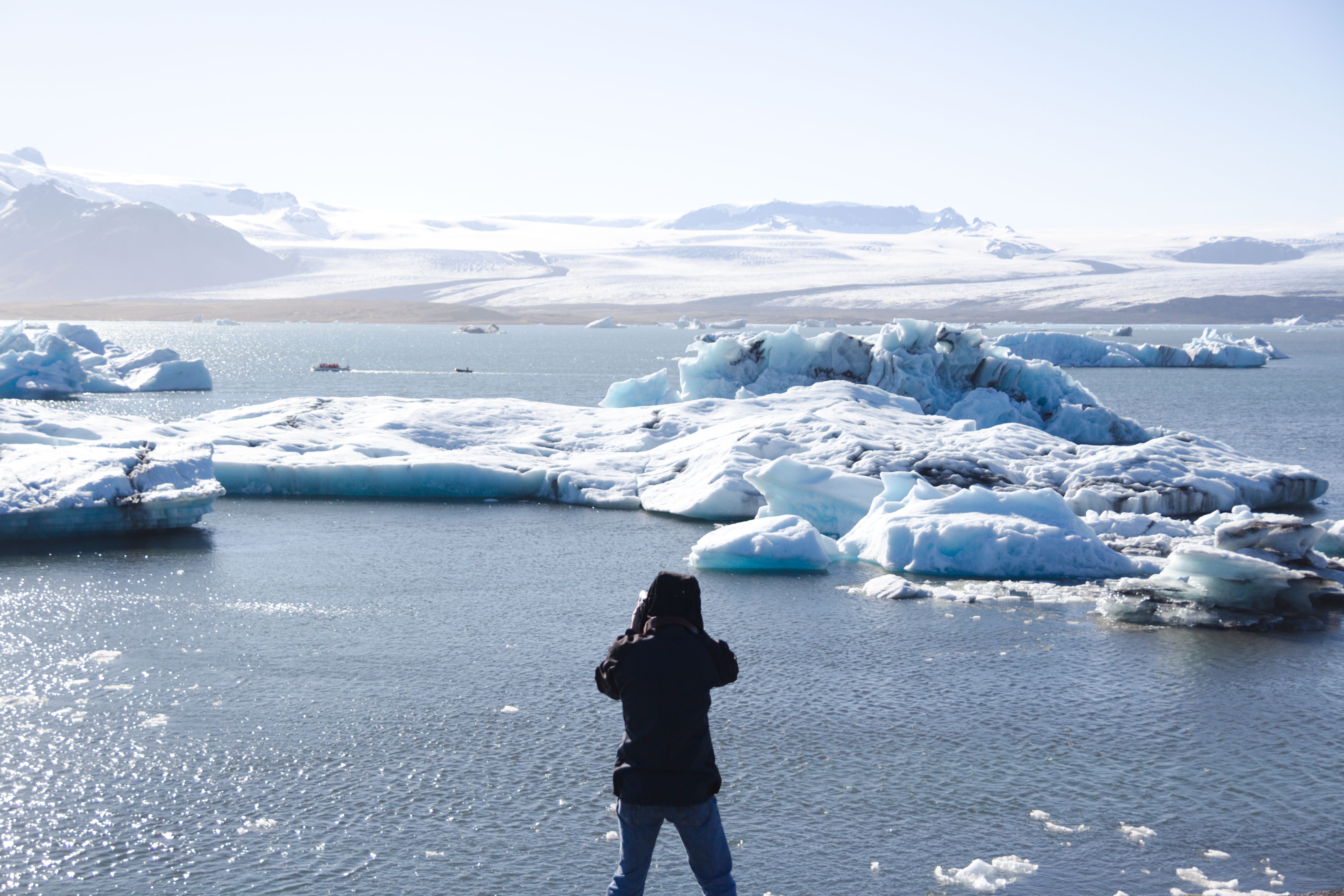 img of man looking across icebergs in iceland